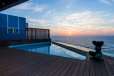 View of ocean by pool of exterior villa