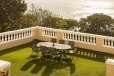 Balcony of bedroom overlooking lawn and terrace